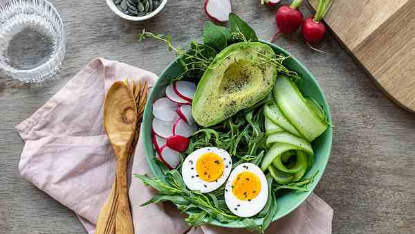 A balanced meal bowl with vegetables and grains on a table