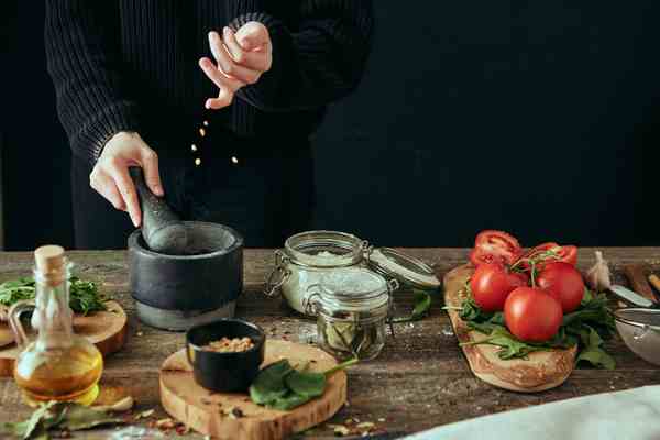 Hands preparing food on a cutting board in a bright kitchen
